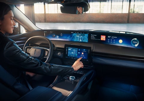 The driver of a 2024 Lincoln Nautilus® SUV interacts with the center touchscreen. | Pugmire Lincoln of Marietta in Marietta GA